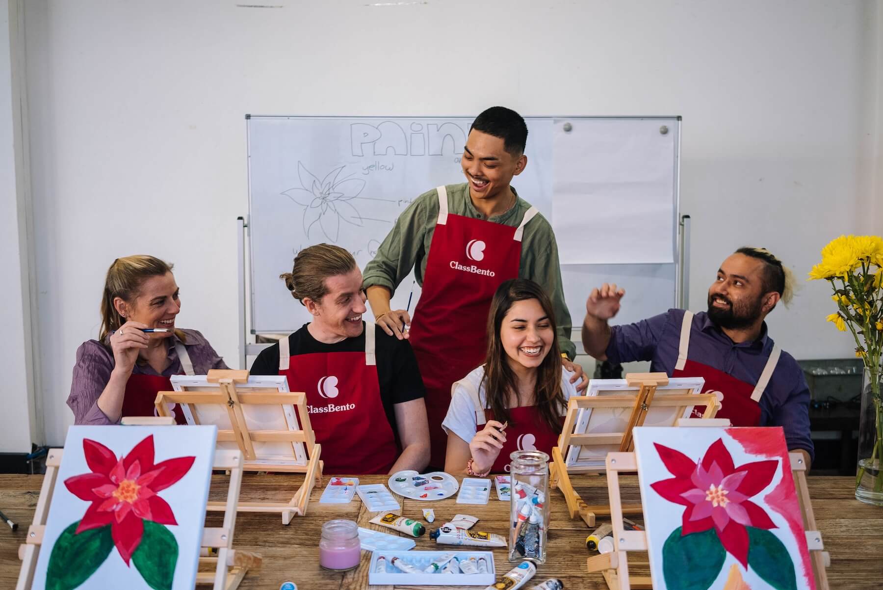 Teacher leading a creative painting workshop with students