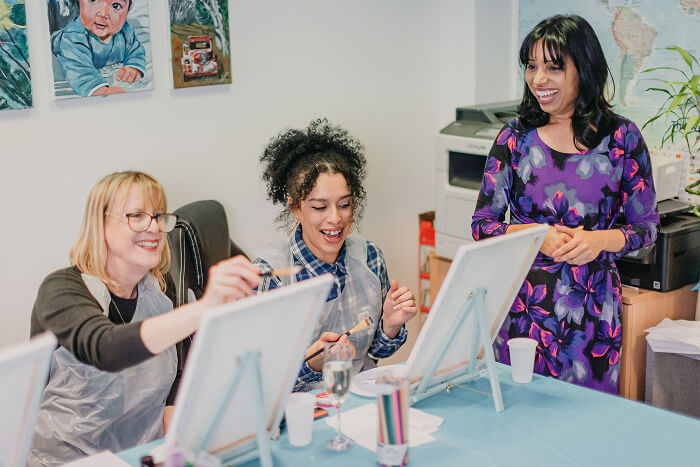 Teacher leading a creative painting workshop with students